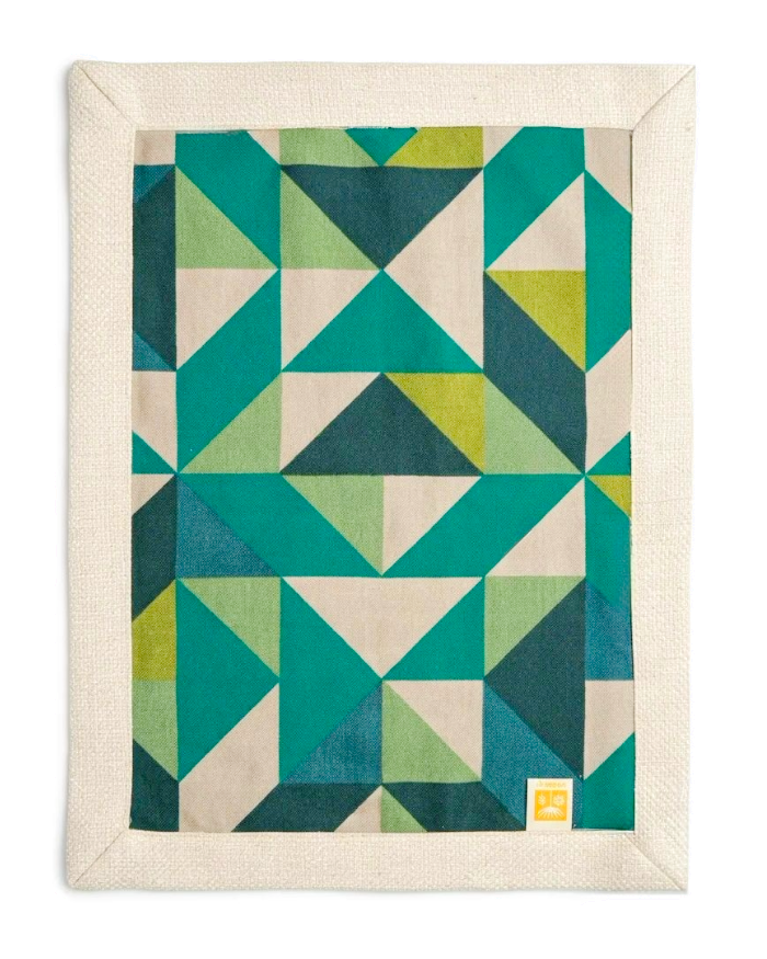Green geometric side of Mosaic placemat laid flat